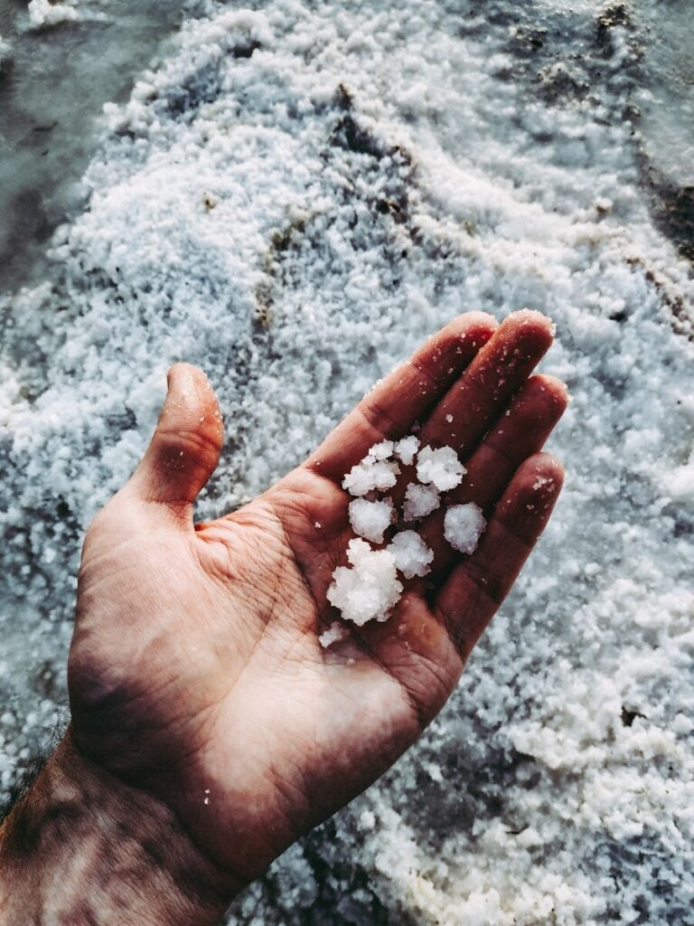 white stones on persons hand