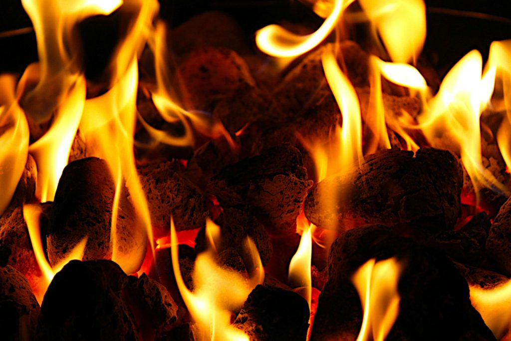 a close up of a fire with flames coming out of it